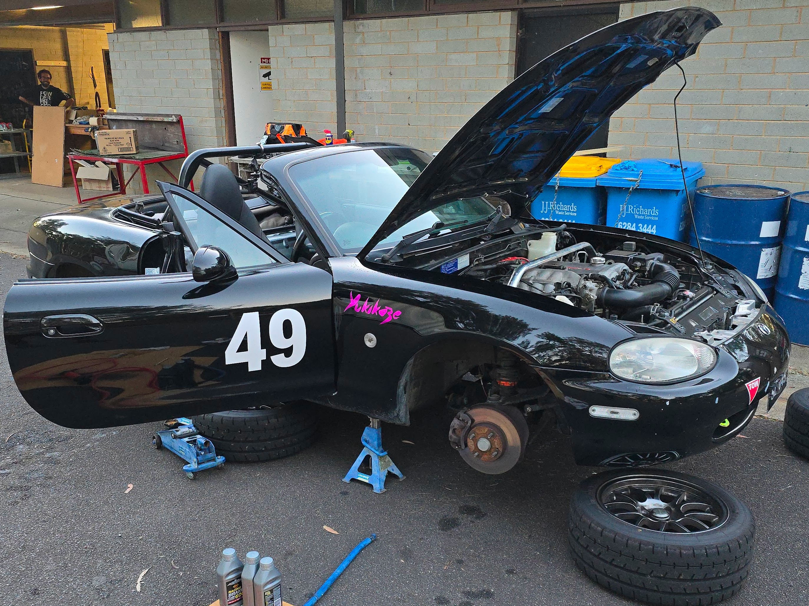 A car on jackstands outside Canberra Makerspace