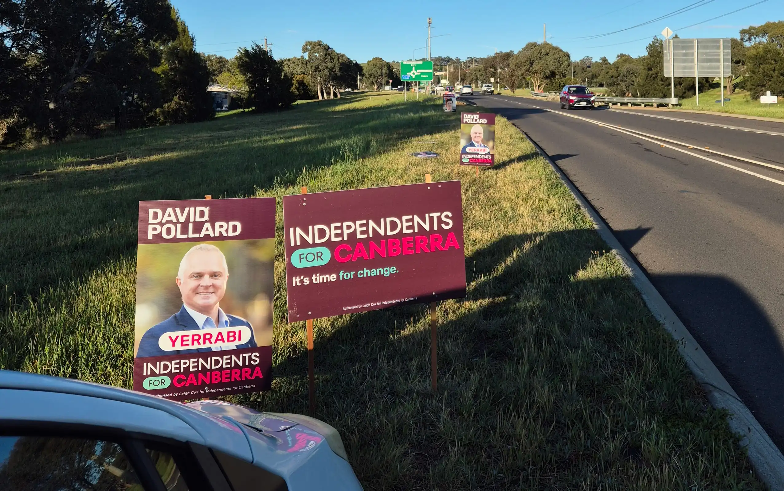 Political campaign corflute on side of road